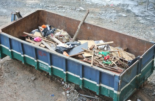 Small skip and van outside a residential terrace in Crouch End