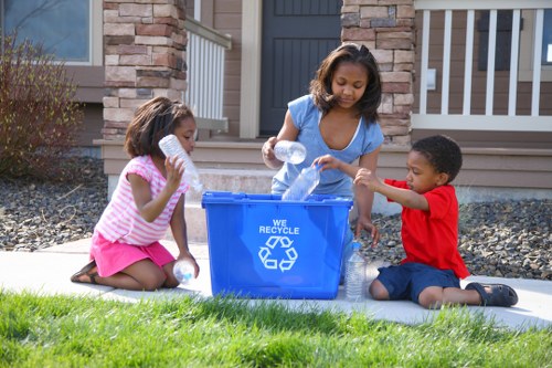 Family unloading waste into a grab hire container